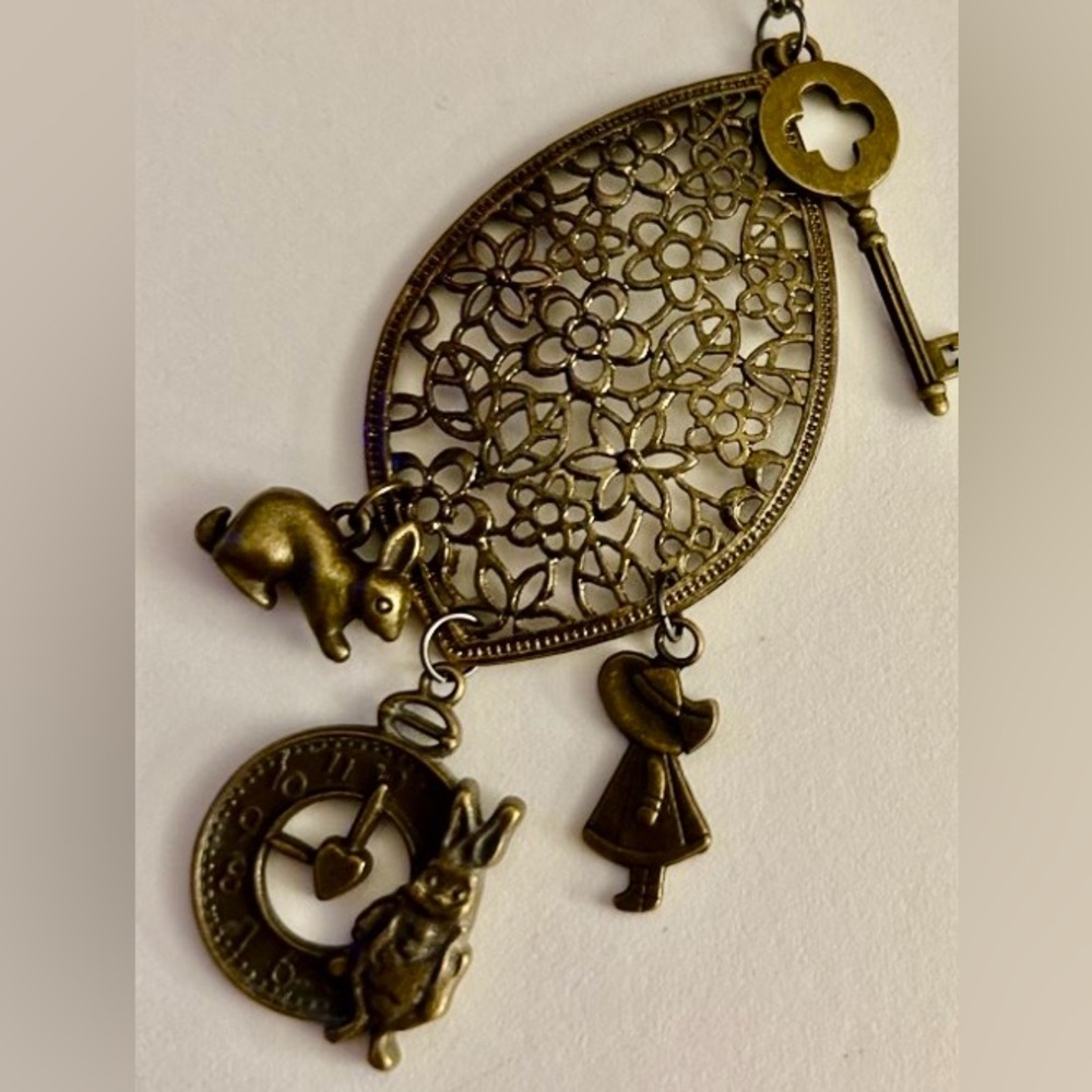 Necklace Alice in Wonderland bronze charms on floral  oval medallion 24” chain